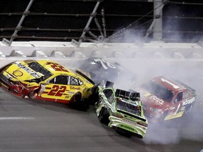 Joey Logano (22), Kyle Busch (18), Jamie McMurray and Martin Truex Jr. (78) get caught up in a wreck in Turn 2 during the NASCAR Cup auto race at Daytona International Speedway, Saturday, July 1, 2017, in Daytona Beach, Fla. (AP Photo/Bill Friel)