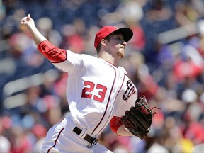 Washington Nationals starting pitcher Erick Fedde throws his first pitch in the Major League during the first inning of a baseball game between the Colorado Rockies and Washington Nationals, Sunday, July 30, 2017, in Washington. (AP Photo/Mark Tenally)