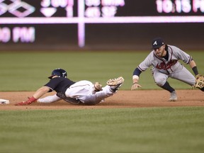 Washington Nationals' Stephen Drew, left, slides to second with a double against Atlanta Braves shortstop Dansby Swanson, right, during the sixth inning of a baseball game, Friday, July 7, 2017, in Washington. (AP Photo/Nick Wass)