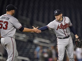 Atlanta Braves' Freddie Freeman celebrates with Jim Johnson (53) after the team's baseball game against the Washington Nationals, early Friday, July 7, 2017, in Washington. The Braves won 5-2. (AP Photo/Nick Wass)