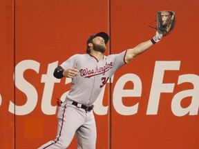 Washington Nationals right fielder Bryce Harper reaches out to catch a fly ball by St. Louis Cardinals' Randal Grichuk during the fourth inning of a baseball game Friday, June 30, 2017, in St. Louis. (AP Photo/Jeff Roberson)