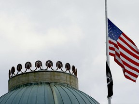The United States flag flies at half-staff over the state Capitol in Raleigh, N.C., Wednesday, July 12, 2017, following the death of six Marines and a Navy sailor from Camp Lejeune, who were among the 16 service members killed Monday when their plane crashed in a field in rural Mississippi. The plane was a KC-130T, a tanker from Marine Aerial Refueling and Transport Squadron 452, a Marine Forces Reserve unit based in Fort Stewart, N.Y. (AP Photo/Gerry Broome)