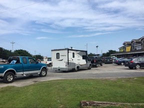 Vehicles line up at the a gas station on Thursday, July 27, 2017, on Ocracoke Island on North Carolina's Outer Banks, as visitors leave the island and residents fuel up.