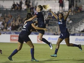 From left, Ashley Hatch, McCall Zerboni, and Jess McDonald celebrate Zerboni's goal against the Seattle Reign in Cary, N.C., Saturday July 8, 2017. Even though Jess McDonald missed a few games because of a hamstring injury, she was not frustrated watching the N.C. Courage from the sidelines. That's because the veteran forward got to play cheerleader for the top team in the National Women's Soccer League. (Fabian Radulescu/The News & Observer via AP)