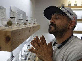 Lucio Ortiz shops for marijuana at The Source dispensary, Saturday, July 1, 2017, in Las Vegas. Recreational marijuana became legal in Nevada on Saturday. (AP Photo/John Locher)