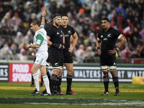 French referee Jerome Garces, left, shows a red card to New Zealand inside center Sonny Bill Williams, second right, to send him from the field as captain, second left, watches during the second rugby test between the British and Irish Lions and the All Blacks in Wellington, New Zealand, Saturday, July 1, 2017. (Mark Mitchell/New Zealand Herald via AP)
