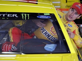 Driver Joey Logano climbs into his car as he prepares for a practice session for Sunday's NASCAR Cup Series 301 auto race at the New Hampshire Motor Speedway in Loudon, N.H., Saturday, July 15, 2017. (AP Photo/Charles Krupa)