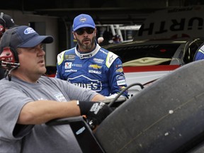 Driver Jimmie Johnson walks from his garage after a NASCAR auto racing practice at the New Hampshire Motor Speedway in Loudon, N.H., Friday, July 14, 2017. (AP Photo/Charles Krupa)