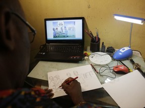 In this photo taken Thursday, June. 22, 2017, Mike Asukwo, a cartoonist sketches one of his works inside his studio in Lagos, Nigeria. Few people think it's funny that Nigeria's president is on extended medical leave in London for the second time this year. But Mike Asukwo sharpens his pencil as he plans his next political cartoon. "Most of the cartoons I do have political themes and so they are strong commentaries on the affairs of the nation. (AP Photo/Sunday Alamba)