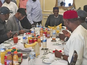 In this Sunday July. 23, 2017 photo released by the Nigeria State House, Nigeria's President Muhammadu Buhari, back centre, during a meeting with Nigeria ruling party's governors, in London Sunday July 23, 2017. Nigeria's government has released the photo of President Muhammadu Buhari more than two months after he left for London for medical treatment amid growing health concerns. (Nigeria State House via AP)