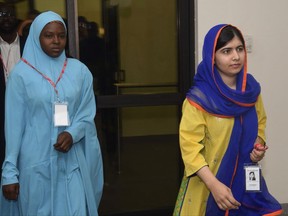 Nigerian activist Amina Yusuf, left, and  Pakistani activist Malala Yousafzai, arrive for a meeting with Nigeria's Acting President Yemi Osinbajo , during a visit at the Presidential villa, in Abuja, Nigeria, Monday, July. 17, 2017. (AP Photo/Azeez Akunleyan)