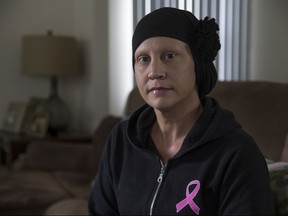 This July 25, 2017 photo shows Jennifer Giordano in her home in Brick, N.J.  Giordano, a cancer patient is suing the state Motor Vehicle Commission for compelling her to remove her headscarf to take a license photo.   Giordano says she was still uncomfortable without wearing a wrap to cover her balding caused by chemotherapy. The lawsuit alleges an employee at the Eatontown office said she had to remove her headscarf for a new license photo,  refusing to use an old photograph Giordano brought with her.  (Doug Hood/The Asbury Park Press via AP)