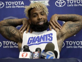New York Giants wide receiver Odell Beckham stretches while talking to reporters at NFL football training camp, Friday, July 28, 2017, in East Rutherford, N.J. (AP Photo/Julio Cortez)