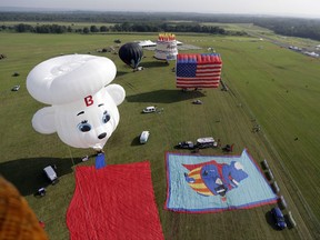 Balloons are seen on the grounds of the Solberg Airport during the first day of flight during the QuickChek New Jersey Festival of Ballooning, Friday, July 28, 2017, in Readington Township, N.J. (AP Photo/Julio Cortez)