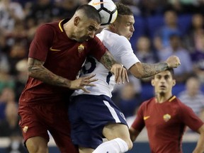 AS Roma's Aleksandar Kolarov, left, and Tottenham's Kieran Trippier go up for the ball during the first half of an International Champions Cup soccer match, Tuesday, July 25, 2017, in Harrison, N.J. (AP Photo/Julio Cortez)