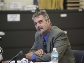 FILE - In this Thursday, July 6, 2017, file photo, John Cramsey, who was pulled over outside the Holland Tunnel and found to be carrying a cache of guns last year and charged, listens during a hearing at the Hudson County Courthouse in Jersey City, N.J. Cramsey, who told police he was heading to the city to rescue a teenage girl from a drug den pleaded guilty on Monday, July 31, to weapons charges. (Ed Murray/NJ Advance Media via AP, Pool, File)