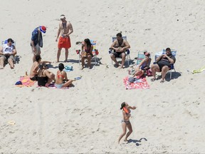 File - In this July 2, 2017 file photo, New Jersey Gov. Chris Christie, right, uses the beach with his family and friends at the governor's summer house at Island Beach State Park in New Jersey.  Christie says public outcry over his decision to lounge with his family on the public beach that was closed during New Jersey's government shutdown "upset his children more than anything else" since he's been in office. The two-term Republican governor made the comments Thursday night, July 27 during his regular radio call in show on 101.5 FM. (Andrew Mills /NJ Advance Media via AP, File)