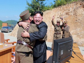 This picture taken on July 4, 2017 and released by North Korea’s official Korean Central News Agency (KCNA) on July 5, shows North Korean leader Kim Jong-Un celebrating the successful test-fire of the intercontinental ballistic missile Hwasong-14 at an undisclosed location.