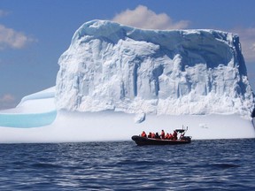 A tour boat cruises pass an iceberg off the coast of Bonavista, N.L. in this undated handout image. Photos of spectacular icebergs on social media are drawing visitors from all over the world to Newfoundland and Labrador. THE CANADIAN PRESS/HO-Discovery Sea Adventures tour company-Bob Currie