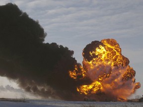 FILE - In this Dec. 30, 2013 file photo, a fireball goes up at the site of an oil train derailment near Casselton, N.D. The end of the line may be in sight for a North Dakota safety program aimed at lowering the risk of disastrous railroad derailments involving the state's crude oil. The pilot program, which includes two rail safety inspectors and a manager to supplement inspections by the Federal Railroad Administration, is halfway through its four-year run this month and likely will be scrapped in two years. (AP Photo/Bruce Crummy, File)