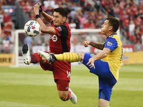 Toronto FC midfielder Marco Delgado (18) and Colorado Rapids midfielder Dillon Serna (17) battle for the ball during first half MLS soccer action in Toronto on Saturday, July 22, 2017. THE CANADIAN PRESS/Nathan Denette