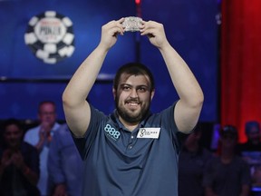 Scott Blumstein holds up the bracelet after winning the World Series of Poker main event, Sunday, July 23, 2017, in Las Vegas. (AP Photo/John Locher)