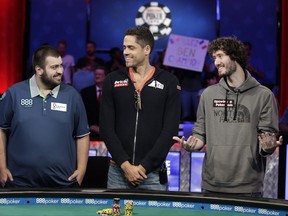 The final three players, from left, Scott Blumstein; Benjamin Pollak, of France; and Dan Ott stand at the final table during the World Series of Poker, Friday, July 21, 2017, in Las Vegas. (AP Photo/John Locher)