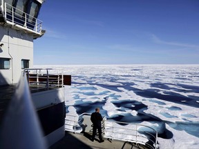 In this Saturday, July 22, 2017 photo, Canadian Coast Guard Capt. Victor Gronmyr looks out over the ice covering the Victoria Strait as the Finnish icebreaker MSV Nordica traverses the Northwest Passage through the Canadian Arctic Archipelago. (AP Photo/David Goldman)
