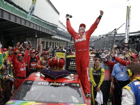 FILE - In this July 26, 2015, file photo, Kyle Busch celebrates after winning the NASCAR Brickyard 400 auto race at Indianapolis Motor Speedway in Indianapolis. Kyle Busch has dominated the Brickyard 400 the last two years. If he can do it again, the 2015 Cup champion would join Michael Schumacher as the only drivers to win three consecutive races at Indianapolis. (AP Photo/Michael Conroy, File)