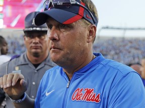 FILE - In this Sept. 17, 2016, file photo, Mississippi head coach Hugh Freeze walks off the field following a loss to No. 1 Alabama in an NCAA college football game, in Oxford, Miss. Gus Malzahn, Kevin Sumlin and Hugh Freeze arrived in the SEC West with reputations for breakneck fast offenses and winning, and have had seasons where they lived up to the billing. All three find themselves potentially on the hot seat, while it's getting a little warm for Arkansas' Bret Bielema and Tennessee's Butch Jones. (AP Photo/Rogelio V. Solis, File)
