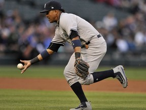 FILE - In this June 26, 2017, file photo, New York Yankees second baseman Starlin Castro bobbles a single hit by Chicago White Sox's Jose Abreu during the first inning of a baseball game in Chicago. Castro will be placed on the disabled list with another injury to his right hamstring, manager Joe Girardi said Saturday, July 22. Castro, activated off the disabled on July 15, reinjured his hamstring while running out a ground ball on Wednesday at Minnesota. He played in the first two games of the series at Seattle on Thursday and Friday with one hit in eight at-bats. (AP Photo/Paul Beaty, File)