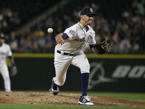 FILE - In this May 31, 2017, file photo, Seattle Mariners relief pitcher Steve Cishek throws in the sixth inning of a baseball game against the Colorado Rockies in Seattle.  The Tampa Bay Rays continued to bolster their bullpen for the pennant race on Friday, July 28, 2017, acquiring Cishek from the Mariners in exchange for versatile right-hander Erasmo Ramirez.  (AP Photo/Ted S. Warren, File)