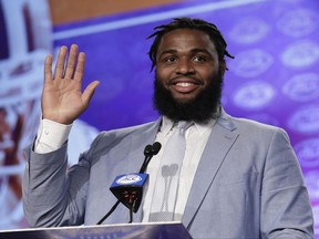 FILE - In this July 13, 2017, file photo, Clemson's Christian Wilkins waves to the media during the Atlantic Coast Conference NCAA college football media day, in Charlotte, N.C. It's Wilkins time to be the face of Clemson _ a role the 6-foot-4, 310-pound junior is more than ready to to take on. (AP Photo/Chuck Burton, File)