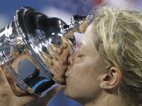 FILE - In this Sept. 11, 2010, file photo, Kim Clijsters, of Belgium, kisses the championship trophy after winning the finals at the U.S. Open tennis tournament in New York. Clijsters will be inducted into the International Tennis Hall of Fame on Saturday, July 22, 2017.(AP Photo/Mark Humphrey, File)