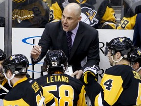 FILe - In this Feb. 3, 2017, file photo, Pittsburgh Penguins assistant coach Rick Tocchet sets up a play during a timeout during the third period of an NHL hockey game against the Columbus Blue Jackets, in Pittsburgh. The Arizona Coyotes have named Rick Tocchet as head coach, replacing Dave Tippett, who parted ways with the franchise after last season. Tocchet spent the past three seasons as an assistant coach of the Pittsburgh Penguins, a stint that included consecutive Stanley Cup championships. (AP Photo/Gene J. Puskar, File)