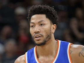FILE - In this March 25, 2017, file photo, New York Knicks' Derrick Rose stands on the court during a free throw attempt in the first half of an NBA basketball game against the San Antonio Spurs, in San Antonio. A person familiar with the negotiations says the Cleveland Cavaliers are discussing a contract with former NBA MVP Derrick Rose. The team is discussing a one-year deal with Rose, said the person who spoke Thursday, July 20, 2017,  to the Associated Press on condition of anonymity because of the sensitive nature of the talks. (AP Photo/Darren Abate)