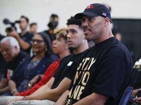 FILE - In this June 23, 2017, file photo, LaVar Ball, right, father of Los Angeles Lakers draft pick Lonzo Ball, listens to his son during the NBA basketball team's news conference in El Segundo, Calif. Ball brought his roadshow to Las Vegas this week for the high school showcase basketball tournaments. As is usually the case, he is stealing the show. (AP Photo/Jae C. Hong, File)