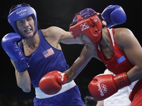 FILE - In this Friday, Aug. 12, 2016 file photo, United States' Mikaela Joslin Mayer, left, fights Micronesia's Jennifer Chieng during a women's lightweight 60-kg preliminary boxing match at the 2016 Summer Olympics in Rio de Janeiro, Brazil. U.S. Olympic boxer Mikaela Mayer announced her decision to pursue a professional career Friday, July 14, 2017 signing with promoter Top Rank. Her debut bout will occur in downtown Los Angeles on Aug. 5. (AP Photo/Frank Franklin II, File)