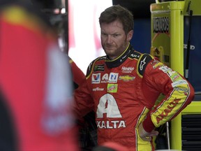 FILE - In this May 19, 2017, file photo, Dale Earnhardt Jr. watches crew members work on his car during practice for a NASCAR Cup series All-Star auto race at Charlotte Motor Speedway in Concord, N.C. Before Dale Earnhardt Jr. calls it a career and starts calling races for NBC, he'd like to salvage a few positive memories from this season. (AP Photo/Chuck Burton, File)