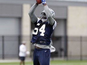 FILE - In this June 13, 2017, file photo, Dallas Cowboys outside linebacker Jaylon Smith (54) reaches up to catch a pass as he participates in drills during an NFL football practice at the team's training facility, in Frisco, Texas. Jaylon Smith was mostly hidden from view rehabbing a knee injury during his first training camp with the Dallas Cowboys a year ago. Now the former Notre Dame standout, taken in the second round of the 2016 draft with the Cowboys, is finally on the field. (AP Photo/Tony Gutierrez, File)