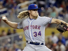 FILE - In this April 14, 2017, file photo, New York Mets pitcher Noah Syndergaard throws during the first inning of the team's baseball game against the Miami Marlins in Miami. Syndergaard and Matt Harvey began their throwing programs Monday, July 17, playing catch together at Citi Field in their first steps toward returning to the mound for the Mets. Whether either one gets back in time to make a difference this season, well, that remains to be seen. (AP Photo/Lynne Sladky, File)