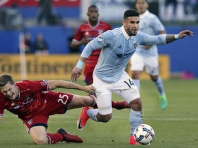 FILE - In this April 22, 2017, file photo, Sporting Kansas City forward Dom Dwyer (14) takes control of the ball against FC Dallas defender Walker Zimmerman (25) during the first half of an MLS soccer match, in Frisco, Texas. Sporting Kansas City forward Dom Dwyer has been traded to Orlando City for what could be a Major League Soccer record $1.6 million in allocation money. (AP Photo/LM Otero, File)