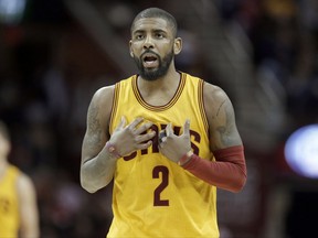 FILE - In this Feb. 27, 2017, file photo, Cleveland Cavaliers' Kyrie Irving talks with a teammate in the first half of an NBA basketball game against the Milwaukee Bucks in Cleveland. Two people familiar with the situation says All-Star guard Kyrie Irving has asked the Cavaliers to trade him. Irving made the request last week to owner Dan Gilbert, said the persons who spoke Friday, July 21, 2017,  to the Associated Press on condition of anonymity because the team is not commenting on the star's demands.  (AP Photo/Tony Dejak, File)