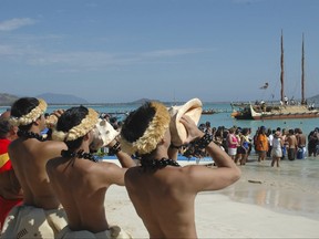 FILE - In this Sunday, May 1, 2005 file photo, traditional Halau dancers blow conch shells to welcome the Hokule'a voyaging canoe into Kailua Bay. The Polynesian double-hulled vessel was built to test anthropological migration theories. For years, Hawaii has ranked as one of the healthiest states, but a study released Friday, July 20, 2017 finds that original Hawaiians are in strikingly poor health. Surveys have long ignored native Hawaiians and other Pacific Islanders, or grouped them in with Asians. (AP Photo/Ronen Zilberman)