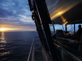 First officer Jukka Vuosalmi sits at the controls of the Finnish icebreaker MSV Nordica as it sets sail in the North Pacific Ocean toward the Bering Strait, Friday, July 7, 2017. A group of international researchers is sailing into the Arctic Sea aboard the Finnish icebreaker to traverse the Northwest Passage and record the environmental and social changes that are taking place in one of the most forbidding corners of the world. (AP Photo/David Goldman)