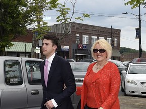 FILE - In this May 19, 2017 file photo, Brooke Covington, a member of the Word of Faith Fellowship church in Spindale, N.C., leaves a hearing at Rutherford County Courthouse accompanied by an attorney, Joshua Valentine, in Rutherfordton, N.C. Covington and other church members are accused of kidnapping and assaulting Matthew Fenner, a former church member, because he is gay. Covington, 58, has pleaded innocent to one count each of kidnapping and assault. If convicted, she faces up to two years in prison. (AP Photo/Kathy Kmonicek)