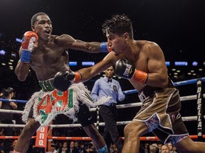 Adrien Broner, left, hits Mikey Garcia during a boxing bout Saturday, July 29, 2017, in New York. (AP Photo/Andres Kudacki)