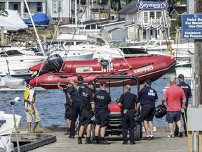 A red rescue boat is hauled out of the water by the Suffolk County Police at the Centerport Yacht Club on Tuesday, July 18, 2017, in Centerport, N.Y. A 10-year-old boy was killed when he fell off a boat and was struck by a propeller while taking sailing lessons on New York's Long Island. Police say it happened after the sailboat he and two others were in was intentionally capsized as part of the lesson. An instructor pulled the boy into an adjacent motor boat, but he then fell out of that boat and was struck by the boat's propeller. (John Paraskevas/Newsday via AP)