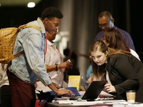 FILE - In this Friday, May 19, 2017, file photo, job seeker Dalvin Jones, left, chats with Valmira Haxhimusa during the Opportunity Fair and Forum employment event in Dallas. On Thursday, July 20, 2017, the Labor Department reports on the number of people who applied for unemployment benefits the week before. (AP Photo/LM Otero, File)