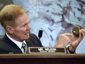 FILE - In this Tuesday, June 23, 2015, file photo, Sen. Bill Nelson, D-Fla., holds a Takata airbag inflator during a Senate Commerce, Science, and Transportation Committee hearing on Capitol Hill in Washington. A government effort to speed up recalls of more than 21 million of the most dangerous Takata air bag inflators is falling short, according to an analysis of completion rates by The Associated Press. (AP Photo/Susan Walsh, File)